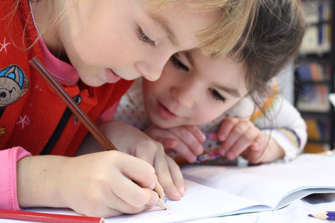 Do Smart Kids Live Longer Than Their Peers - 2 Girls drawing with pencil for thurswell law